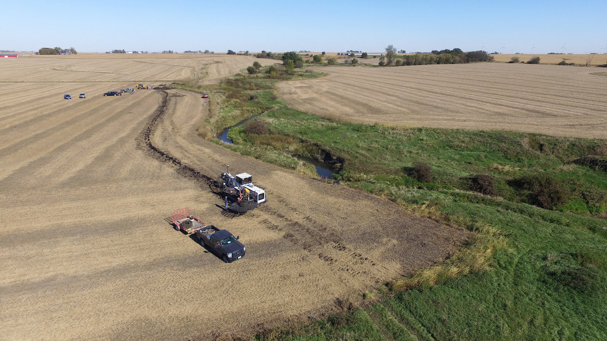 Aerial photo of trucks in farm field by saturated buffer